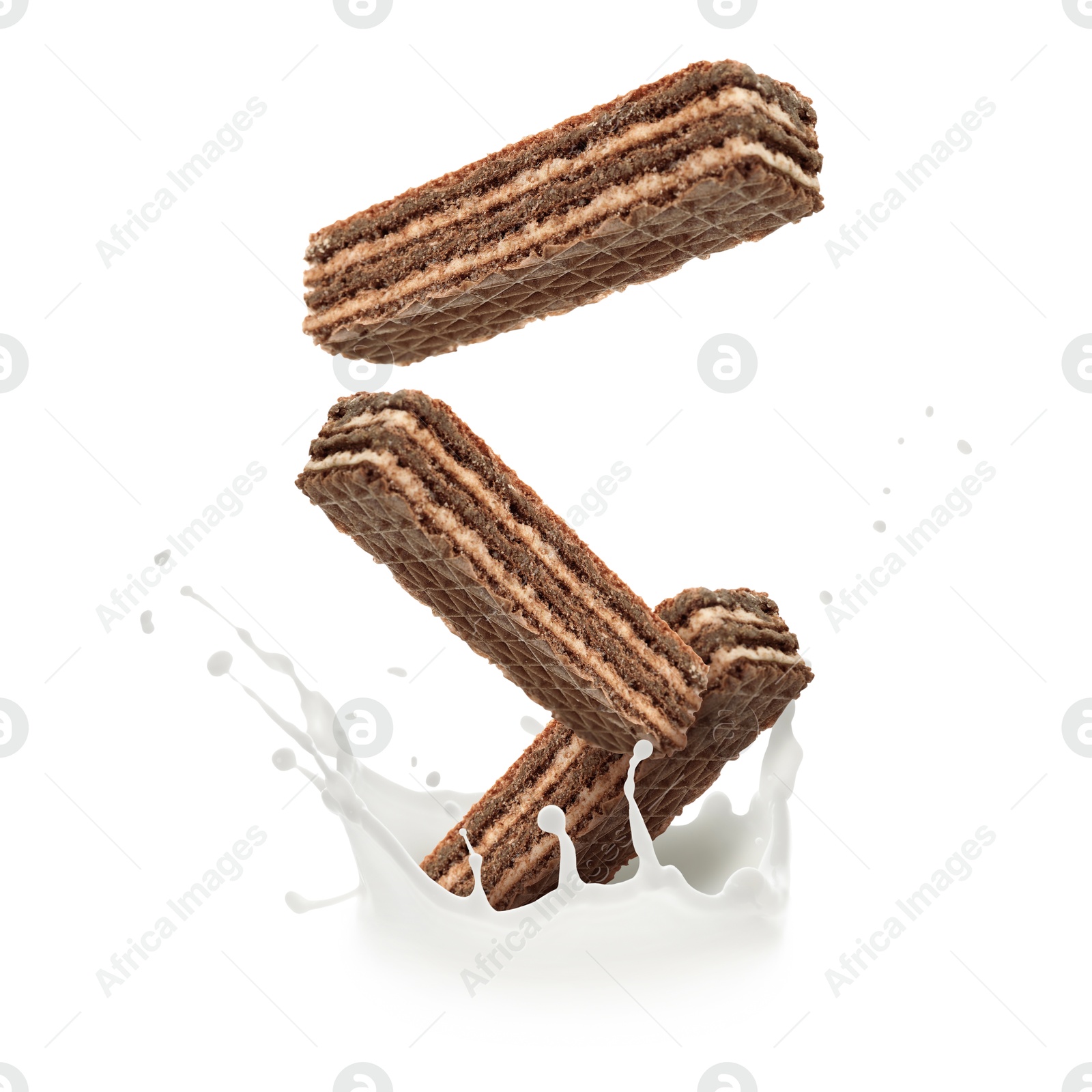 Tasty crispy wafers falling into splashing milk against white background Image of Tasty crispy wafers falling into splashing milk against white background