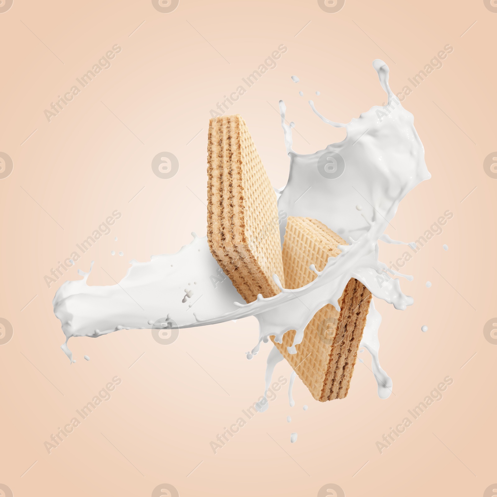Image of Tasty crispy wafers and splashing milk on pink beige background