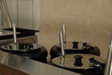 Photo of Cooking pots with tasty food in school canteen