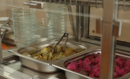 Photo of Containers with tasty food in school canteen