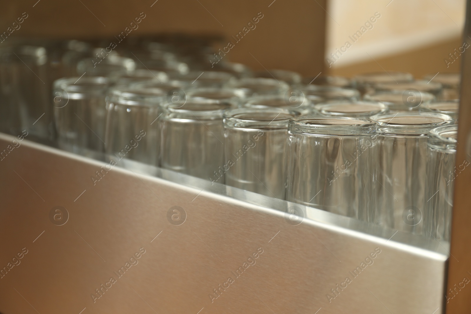 Many clean glasses on stand in school canteen Photo of Many clean glasses on stand in school canteen