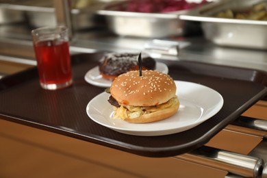 Photo of Plastic tray with tasty food near serving line in school canteen
