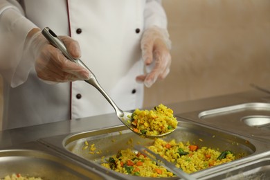 Photo of School canteen worker at serving line, closeup. Tasty food