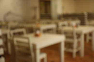 Photo of Blurred view of modern school canteen with new furniture