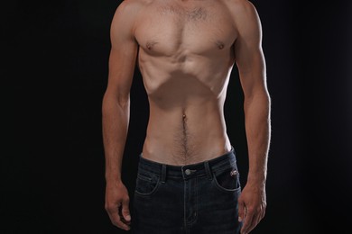 Photo of Man suffering from anorexia on black background, closeup