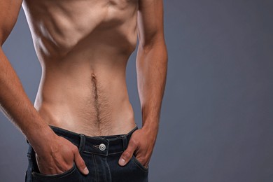 Photo of Man suffering from anorexia on grey background, closeup. Space for text