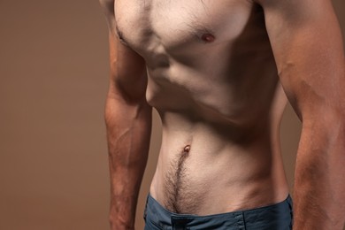 Photo of Man suffering from anorexia on beige background, closeup