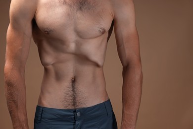 Photo of Man suffering from anorexia on beige background, closeup