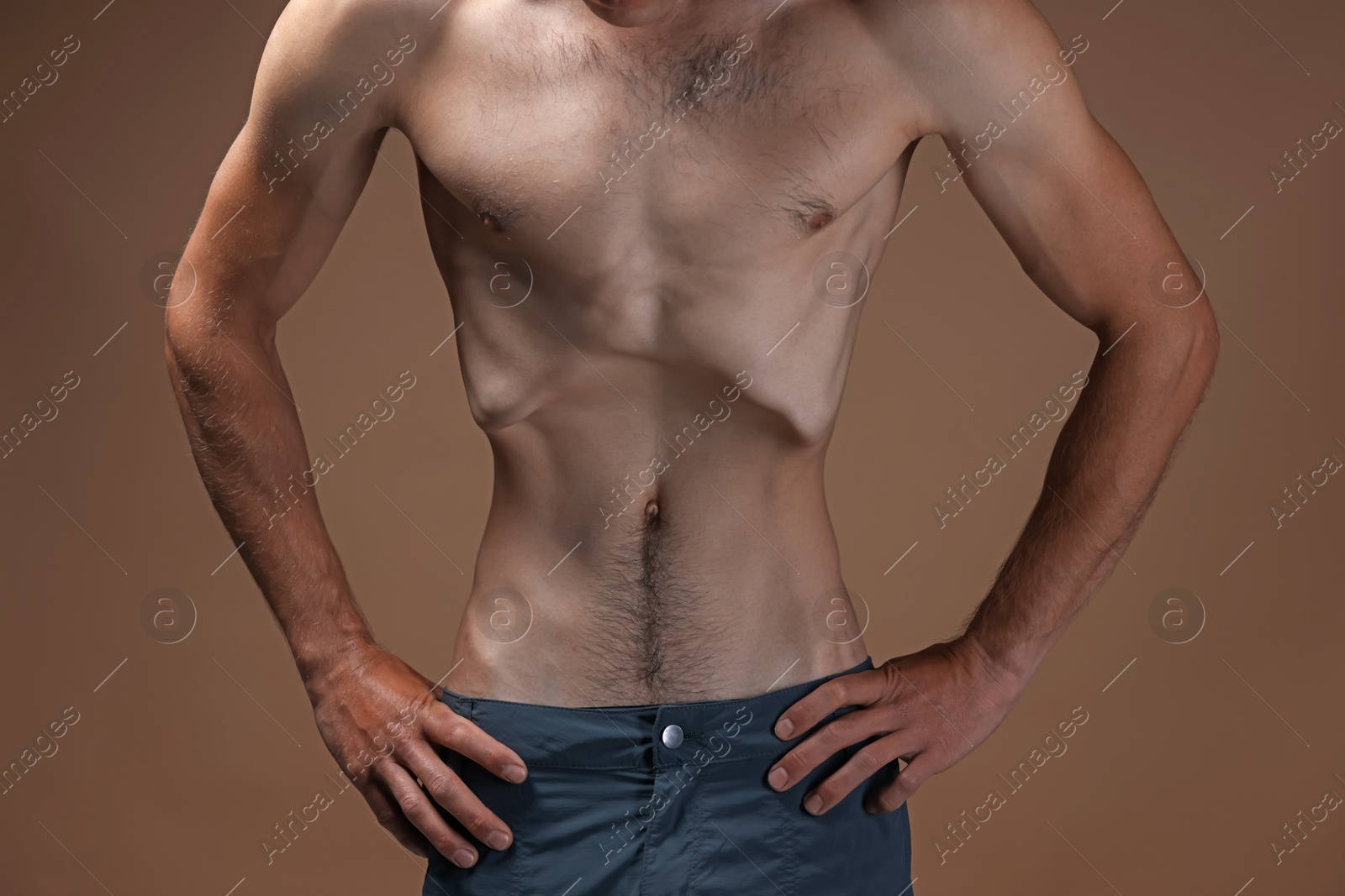 Man suffering from anorexia on beige background, closeup Photo of Man suffering from anorexia on beige background, closeup