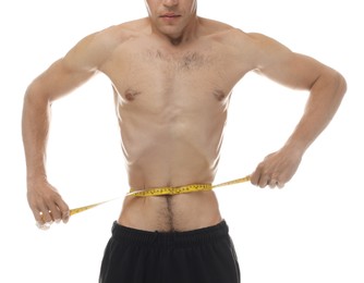 Photo of Anorexic man measuring his waist on white background, closeup