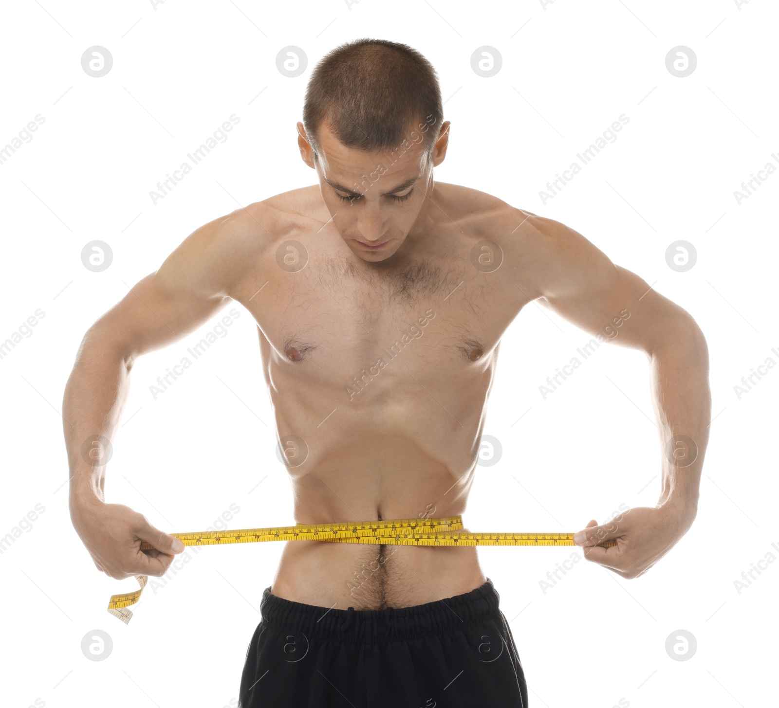 Anorexic man measuring his waist on white background Photo of Anorexic man measuring his waist on white background