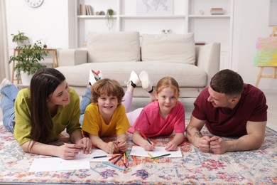 Photo of Parents teaching their kids to draw on floor at home