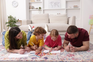 Photo of Parents teaching their kids to draw on floor at home