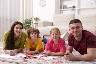 Photo of Parents teaching their kids to draw on floor at home