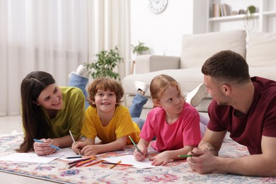 Photo of Parents teaching their kids to draw on floor at home