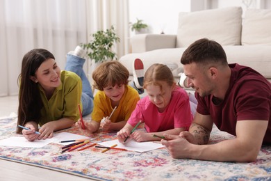 Photo of Parents teaching their kids to draw on floor at home