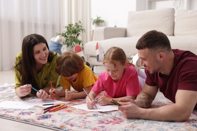 Photo of Parents teaching their kids to draw on floor at home