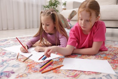 Photo of Cute kids learning to draw on floor at home