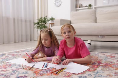 Photo of Cute kids learning to draw on floor at home