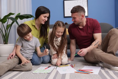 Photo of Parents teaching their kids to draw on floor at home