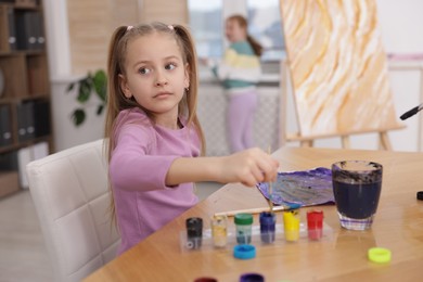 Photo of Cute kids at painting lesson, selective focus. Learning to draw