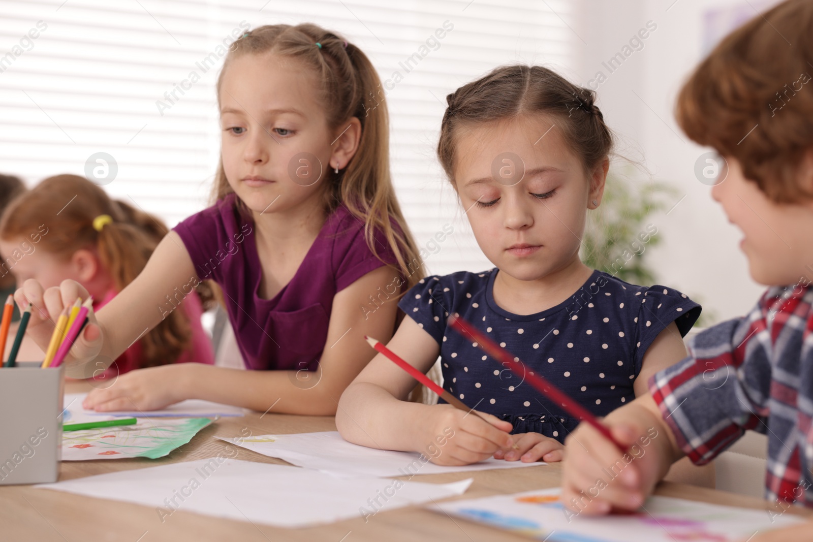 Kids painting at table indoors. Learning to draw Photo of Kids painting at table indoors. Learning to draw