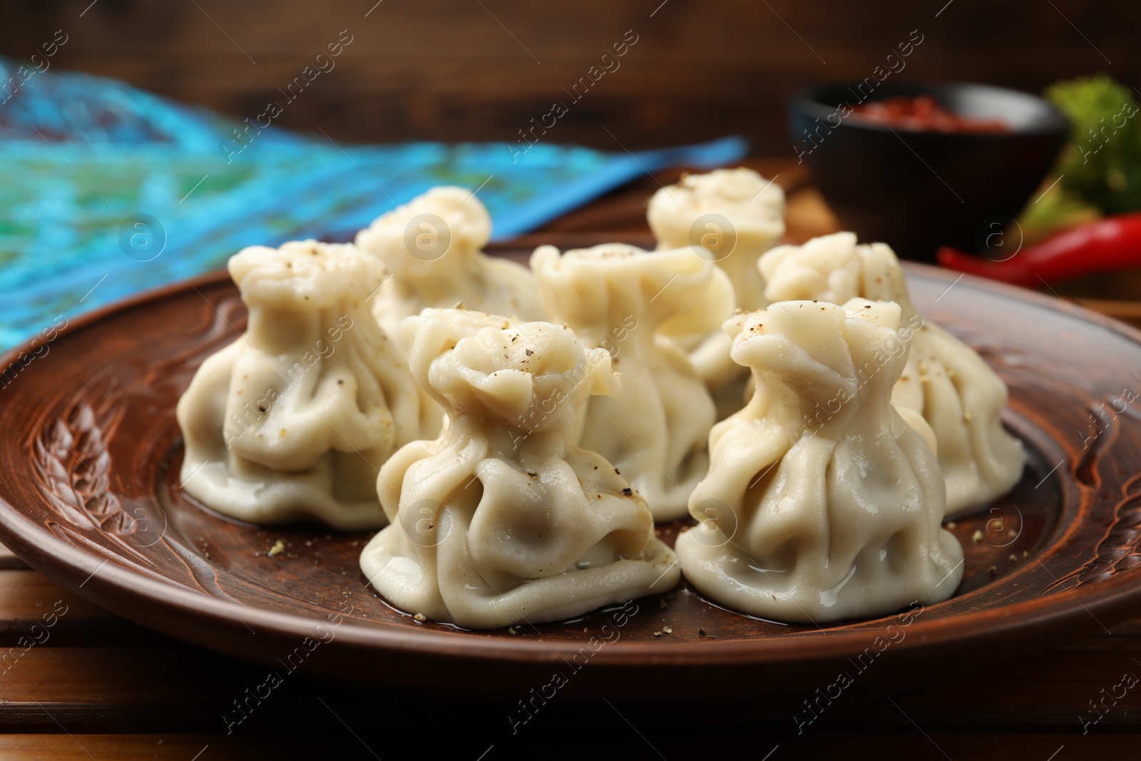 Delicious khinkali served on wooden table, closeup Photo of Delicious khinkali served on wooden table, closeup