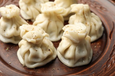 Photo of Delicious khinkali with spices on plate, closeup