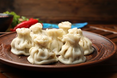 Photo of Delicious khinkali with spices on table, closeup