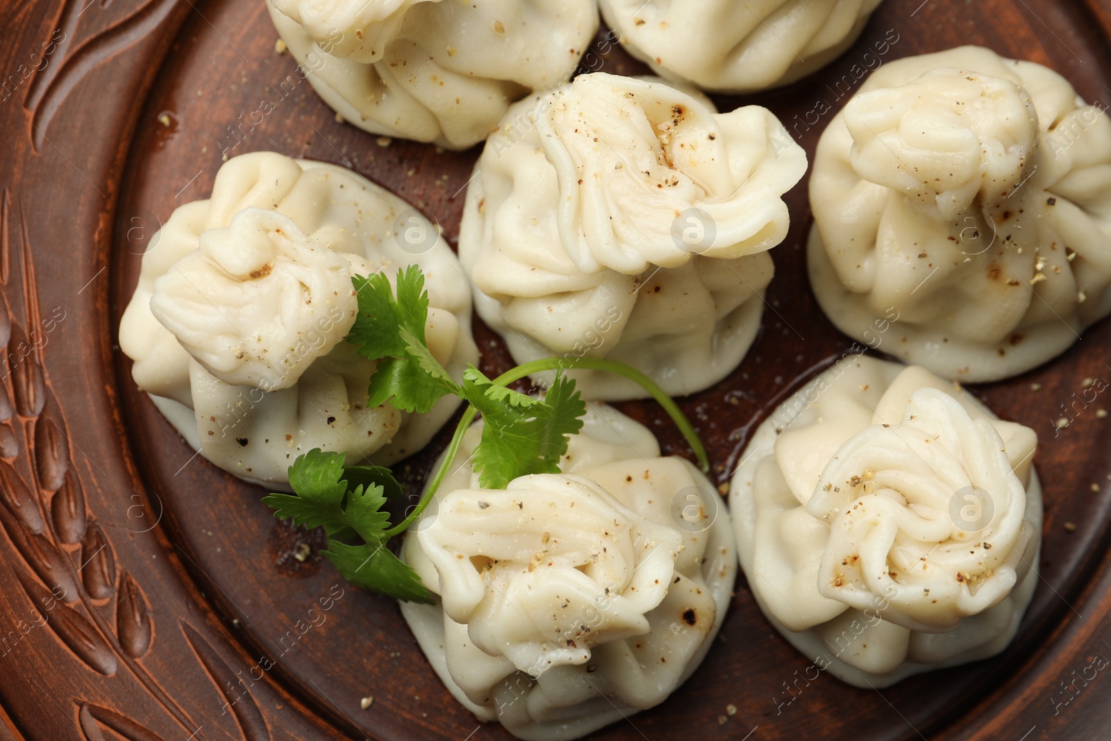 Delicious khinkali with cilantro on plate, top view Photo of Delicious khinkali with cilantro on plate, top view