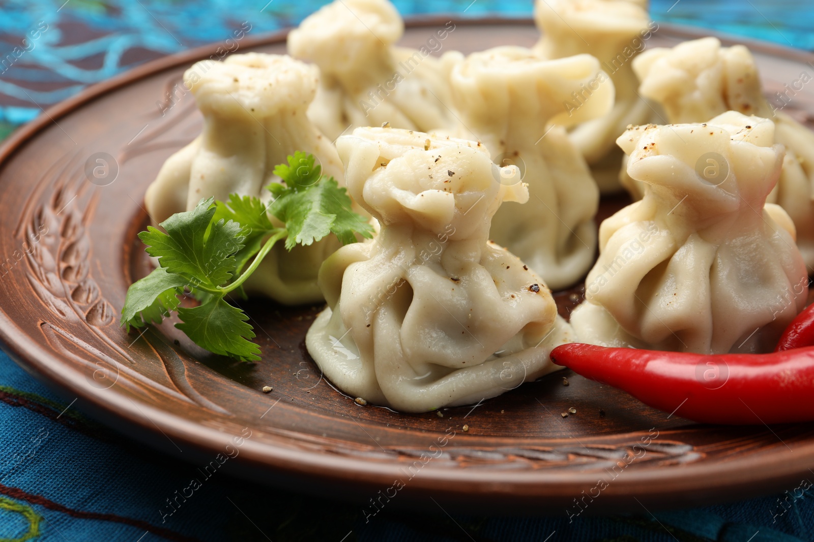 Delicious khinkali with spices on table, closeup Photo of Delicious khinkali with spices on table, closeup