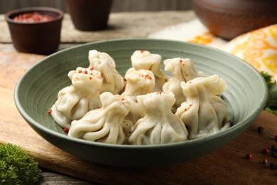 Photo of Delicious khinkali with spices on table, closeup