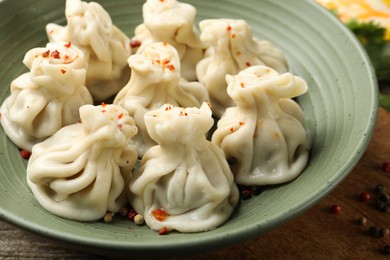 Photo of Delicious khinkali with spices on table, closeup