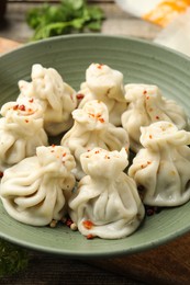 Photo of Delicious khinkali with spices on table, closeup