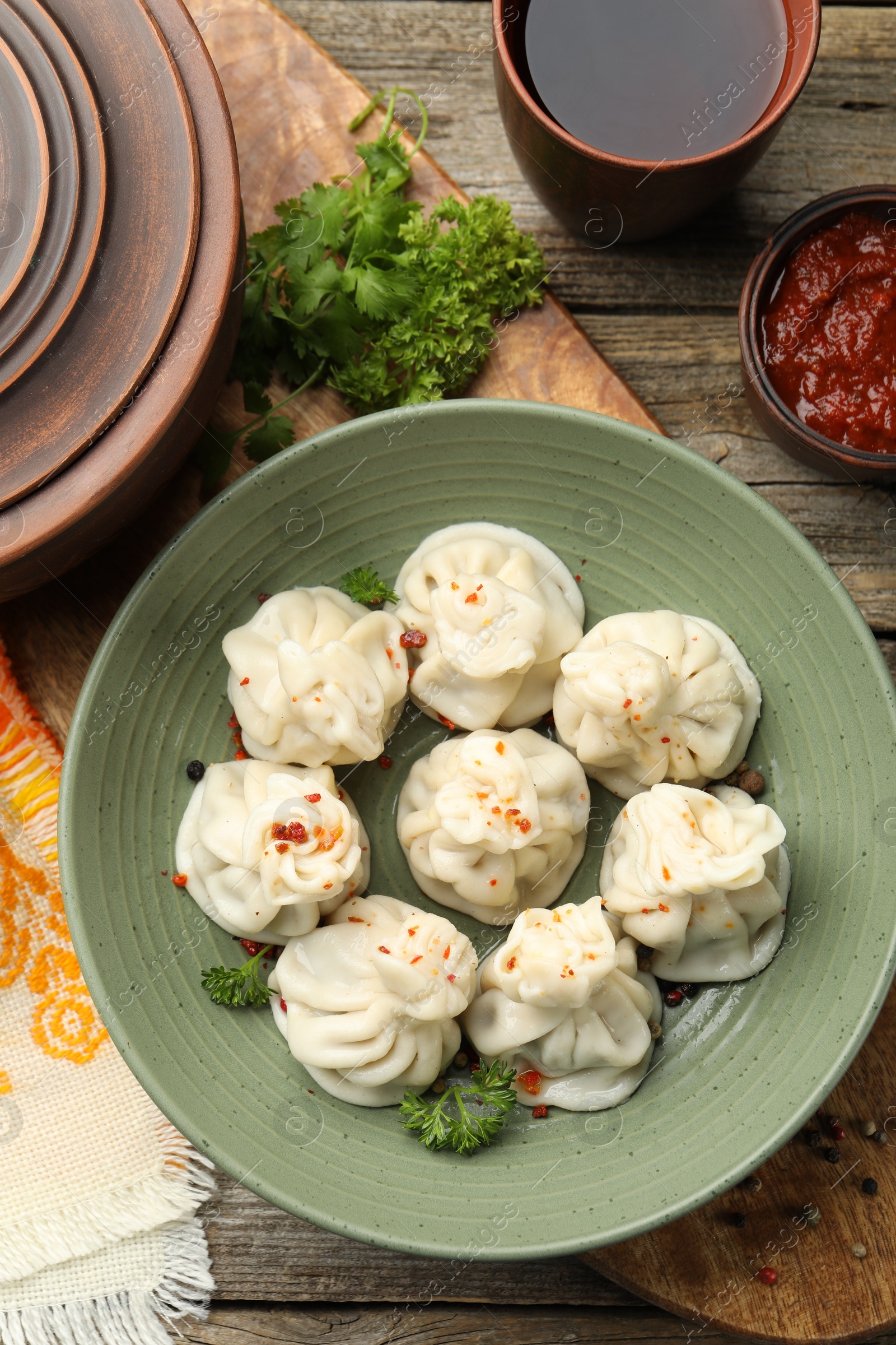 Delicious khinkali served on wooden table, flat lay Photo of Delicious khinkali served on wooden table, flat lay