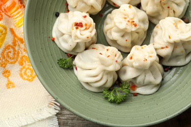 Photo of Delicious khinkali with spices on table, top view