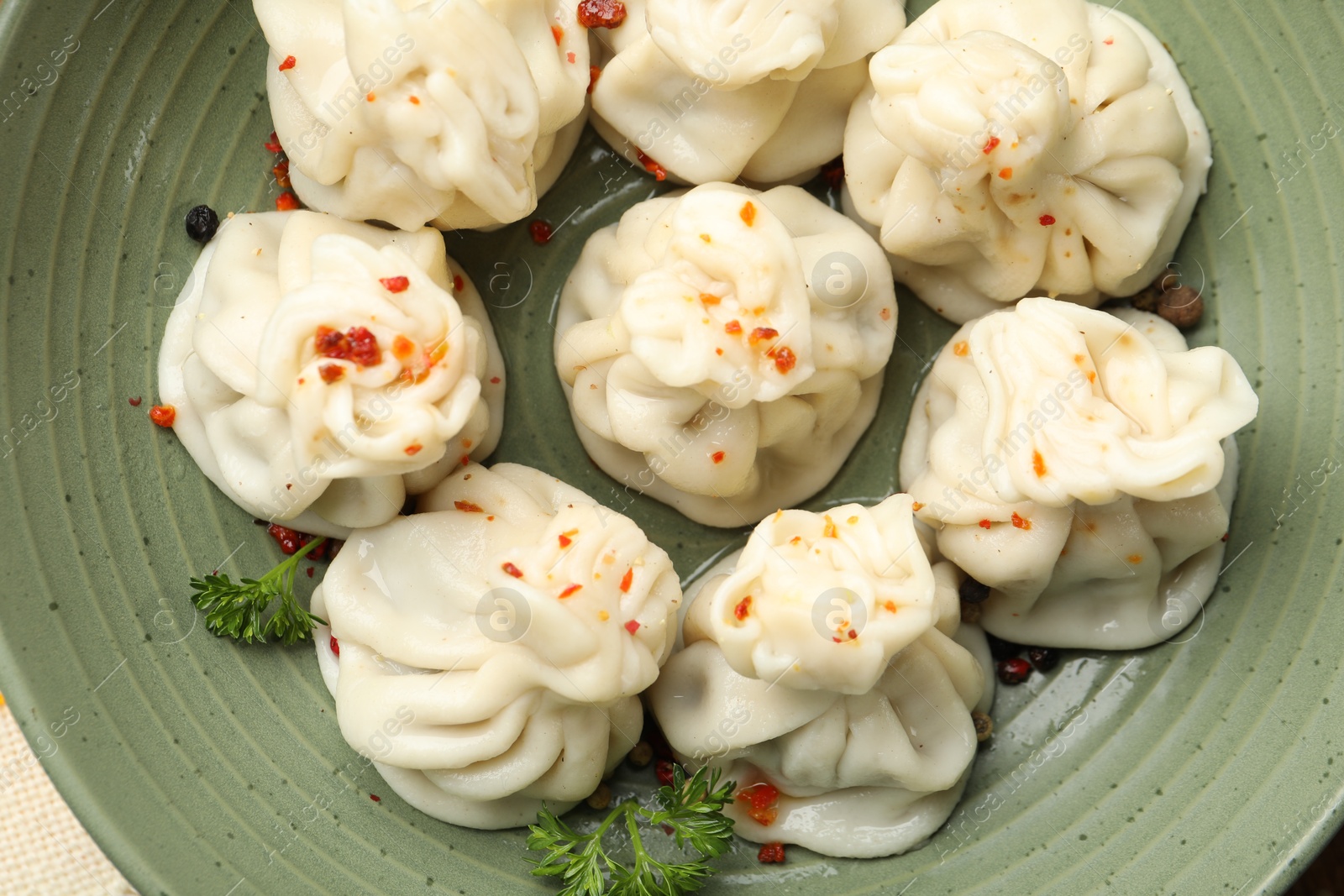 Delicious khinkali with spices in bowl, top view Photo of Delicious khinkali with spices in bowl, top view