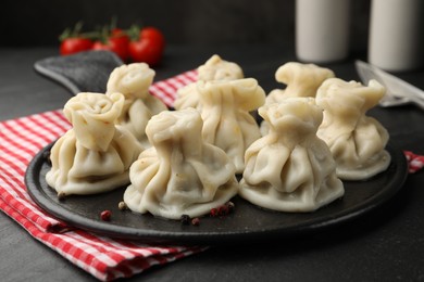 Photo of Delicious khinkali served on black table, closeup