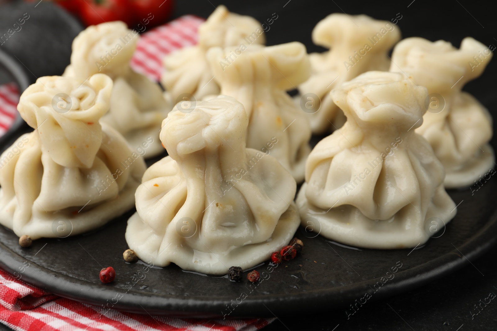 Delicious khinkali with spices on table, closeup Photo of Delicious khinkali with spices on table, closeup
