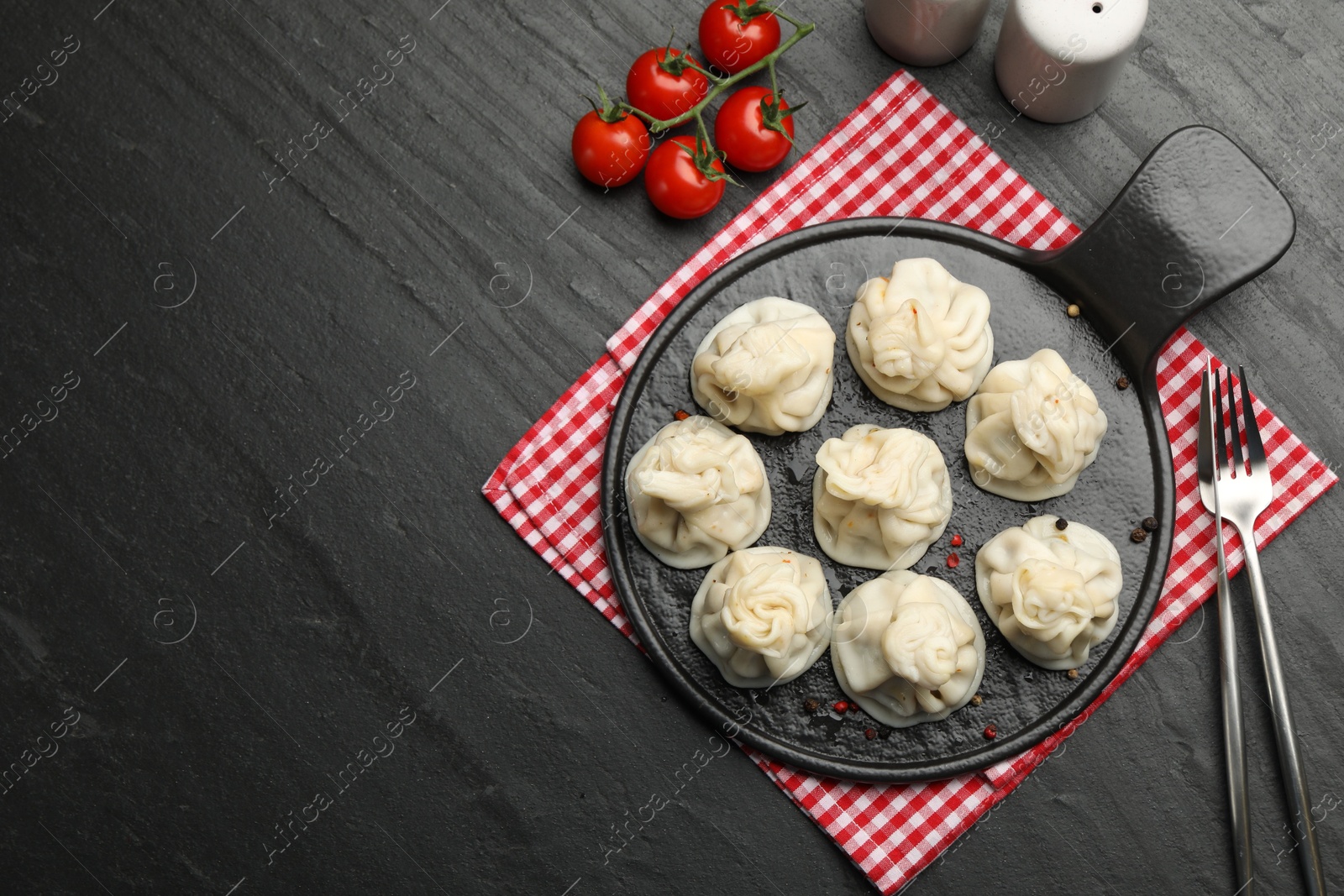 Delicious khinkali served on black table, flat lay. Space for text Photo of Delicious khinkali served on black table, flat lay. Space for text