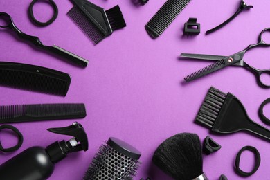 Photo of Frame of different hairdresser's tools on violet background, flat lay. Space for text