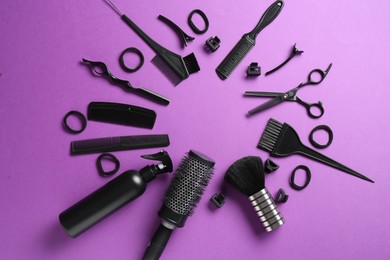 Photo of Frame of different hairdresser's tools on violet background, flat lay. Space for text