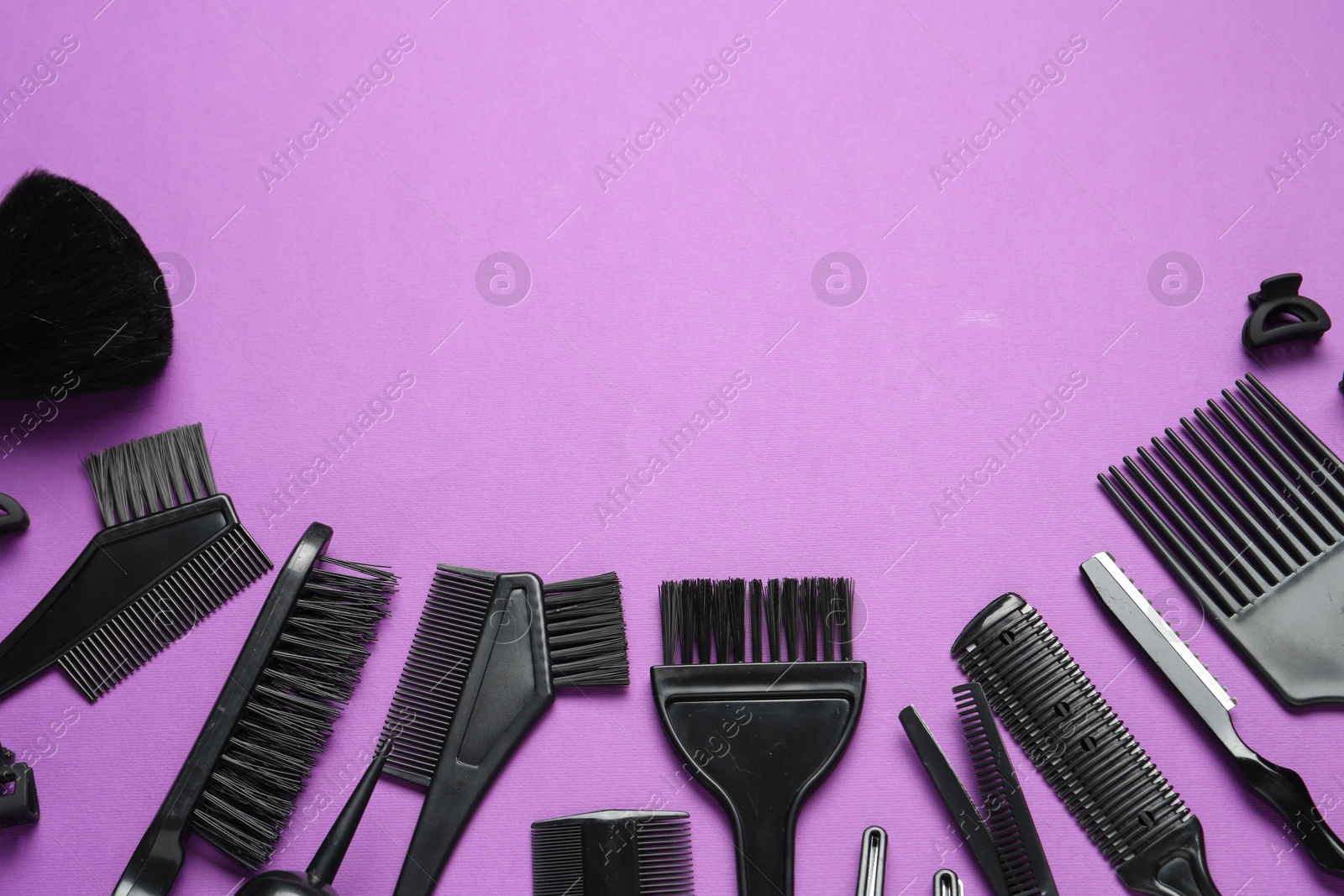 Different hairdresser's tools on violet background, flat lay. Space for text Photo of Different hairdresser's tools on violet background, flat lay. Space for text