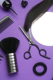 Photo of Different hairdresser's tools on purple background, flat lay