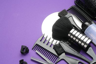 Photo of Different hairdresser's tools on purple background, above view. Space for text