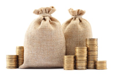 Photo of Bags and stacked coins isolated on white