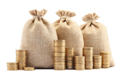 Photo of Bags and stacked coins isolated on white