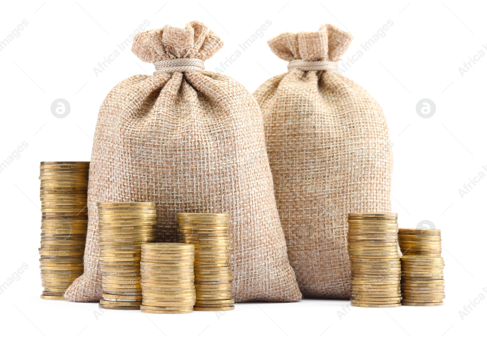 Bags and stacked coins isolated on white Photo of Bags and stacked coins isolated on white