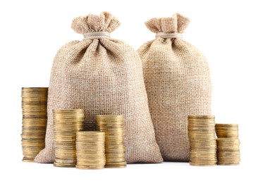 Photo of Bags and stacked coins isolated on white