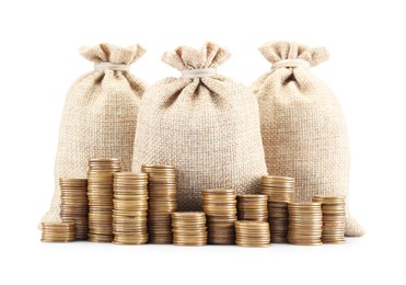 Photo of Bags and stacked coins isolated on white